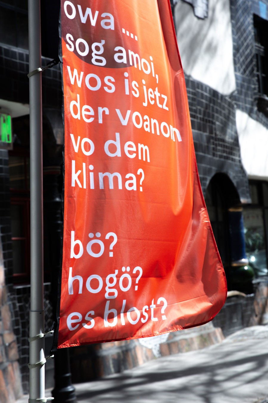 Detail of a flag with written text: scenography festival center of Klima Biennale Wien at KunstHausWien by JASCHA&FRANZ and Andrea Grill