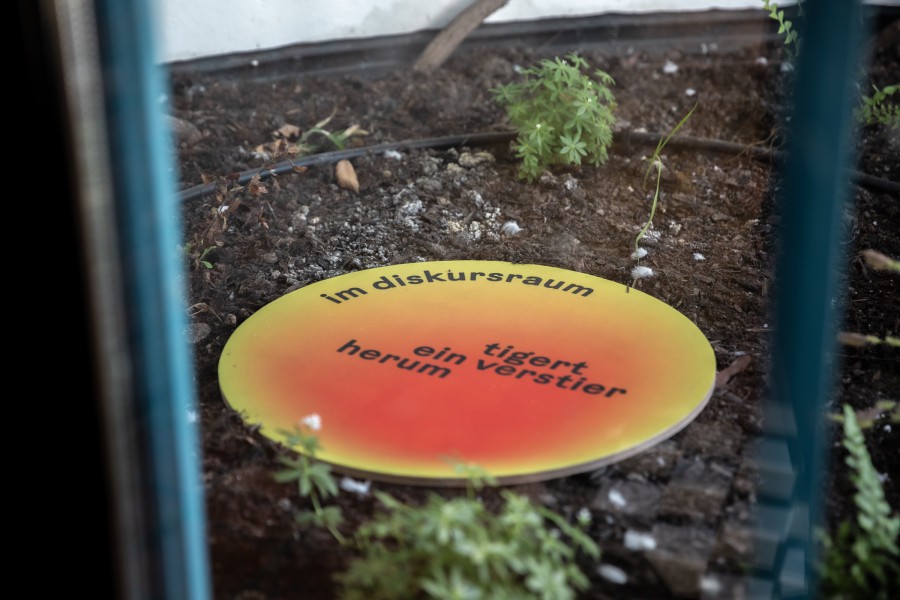 printed wooden plate with text fragment: scenography festival center of Klima Biennale Wien at KunstHausWien by JASCHA&FRANZ and Andrea Grill